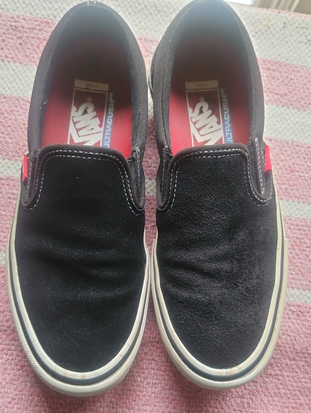 Vans Classic Slip-On Sneakers in Black with Red Insole